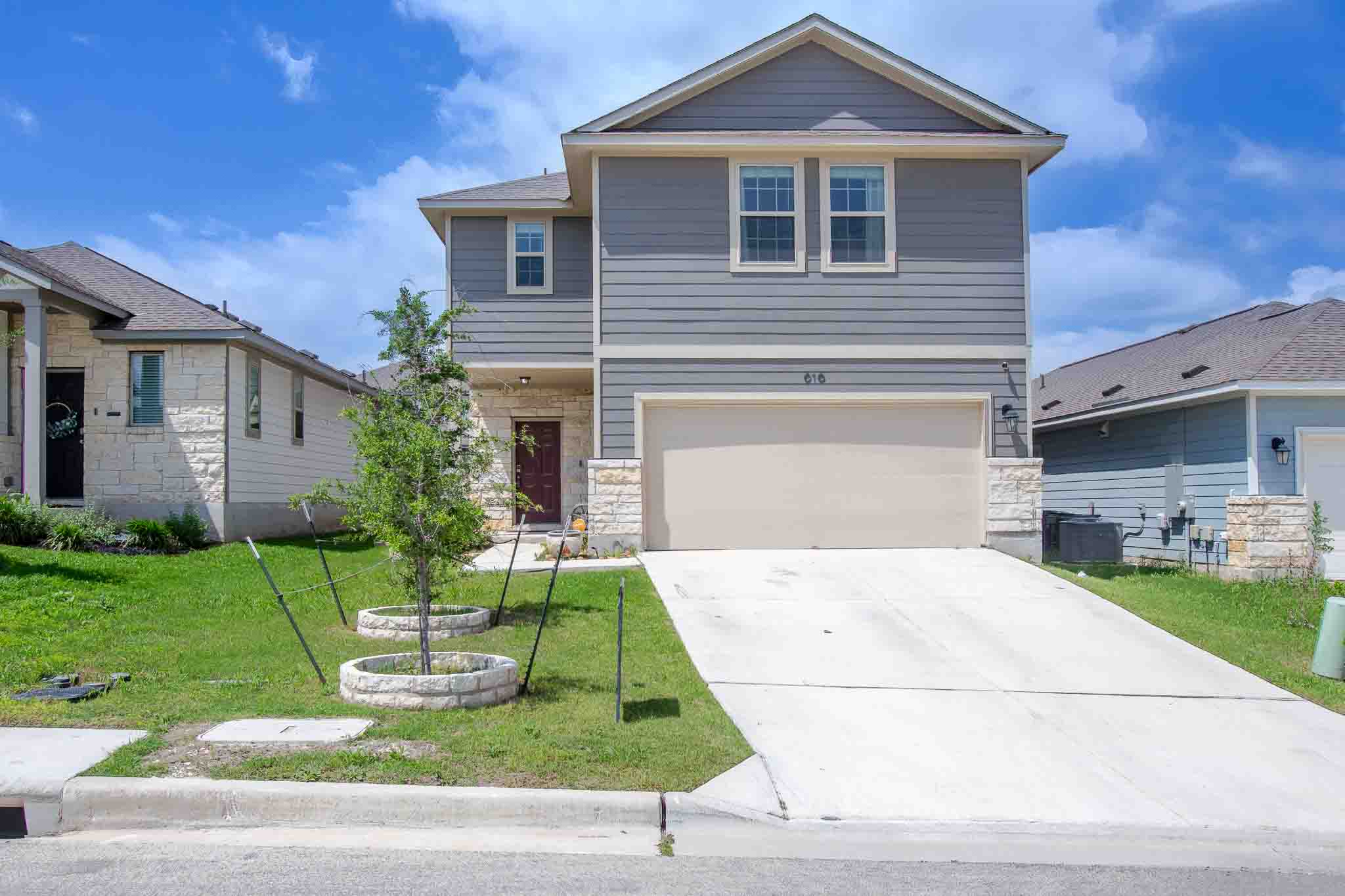 a front view of a house with a yard and garage