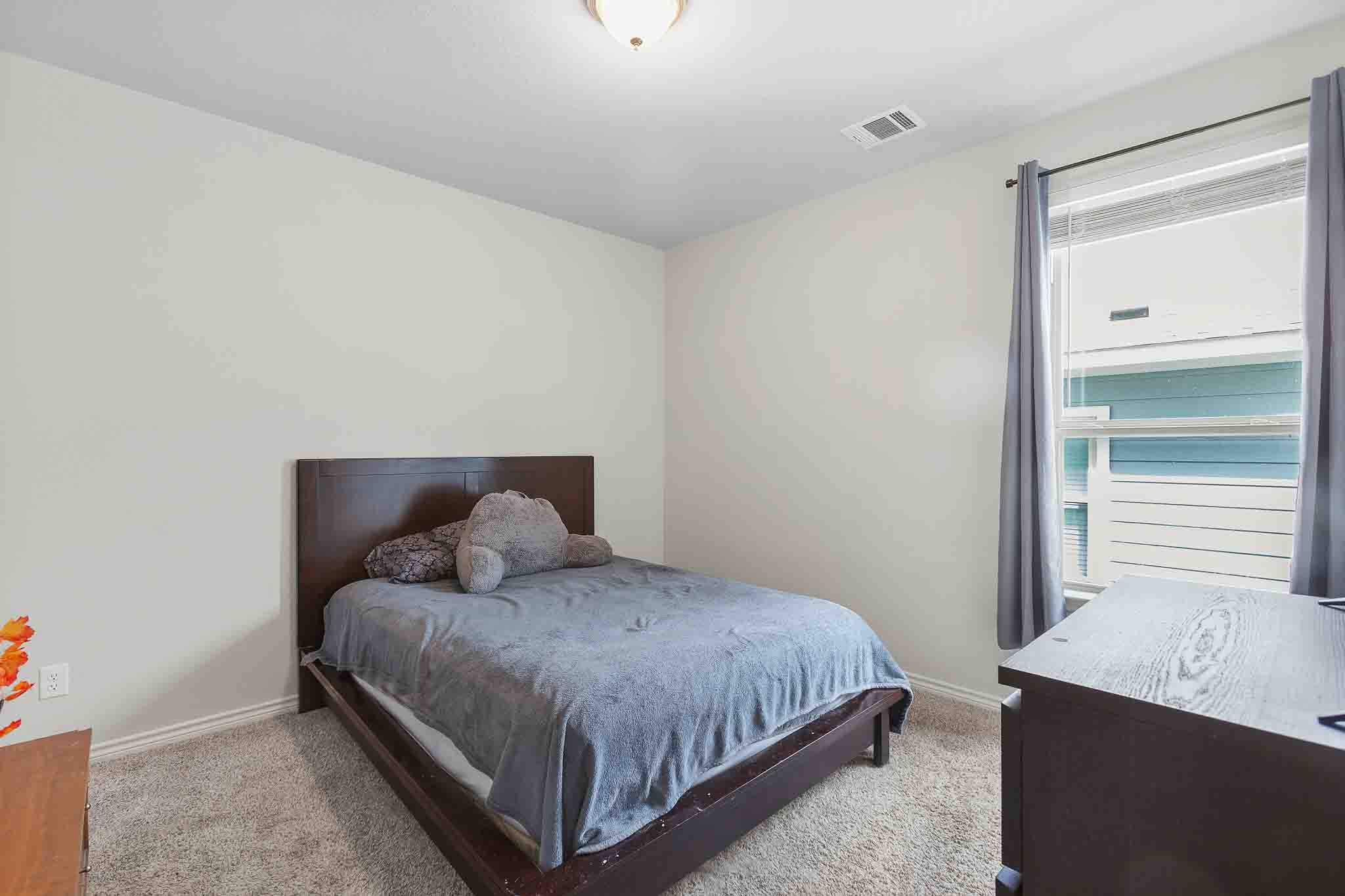 616 Barbary Coast Lane Jarrell, TX 76537 - Photo 13 of 37 a bedroom with a bed and window