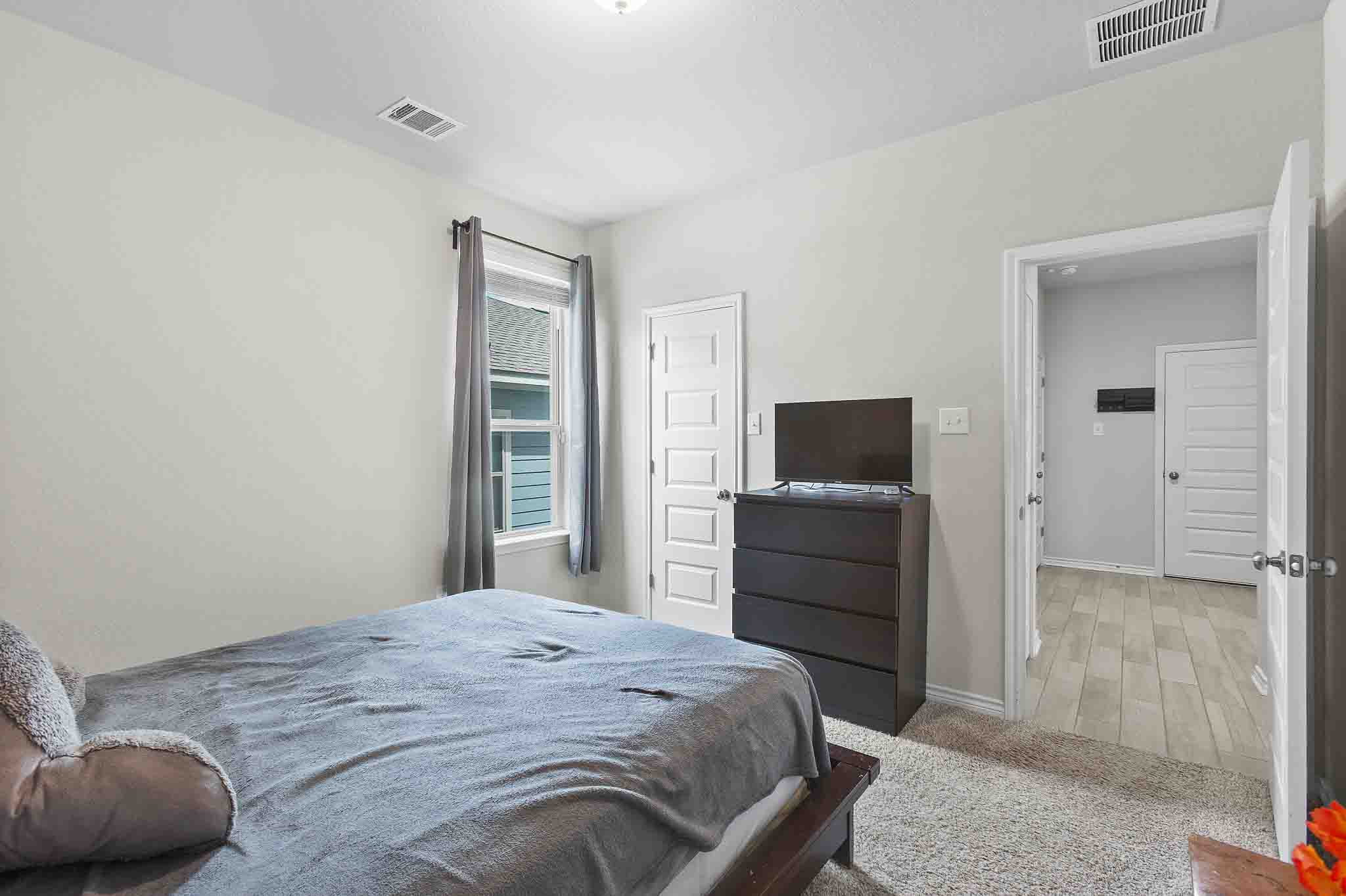 616 Barbary Coast Lane Jarrell, TX 76537 - Photo 14 of 37 a bedroom with a bed and a television in it