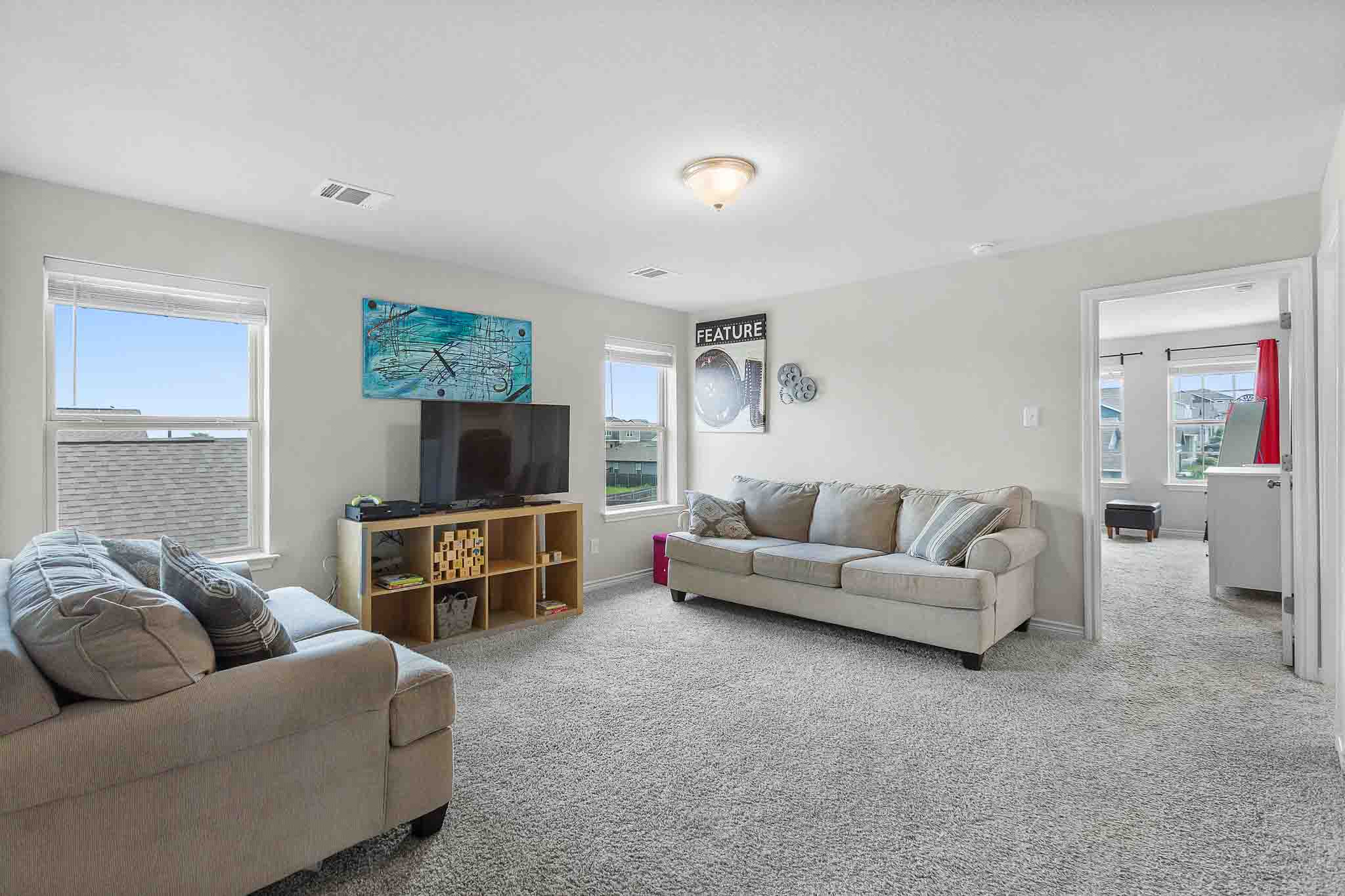 616 Barbary Coast Lane Jarrell, TX 76537 - Photo 17 of 37 a living room with furniture and a flat screen tv