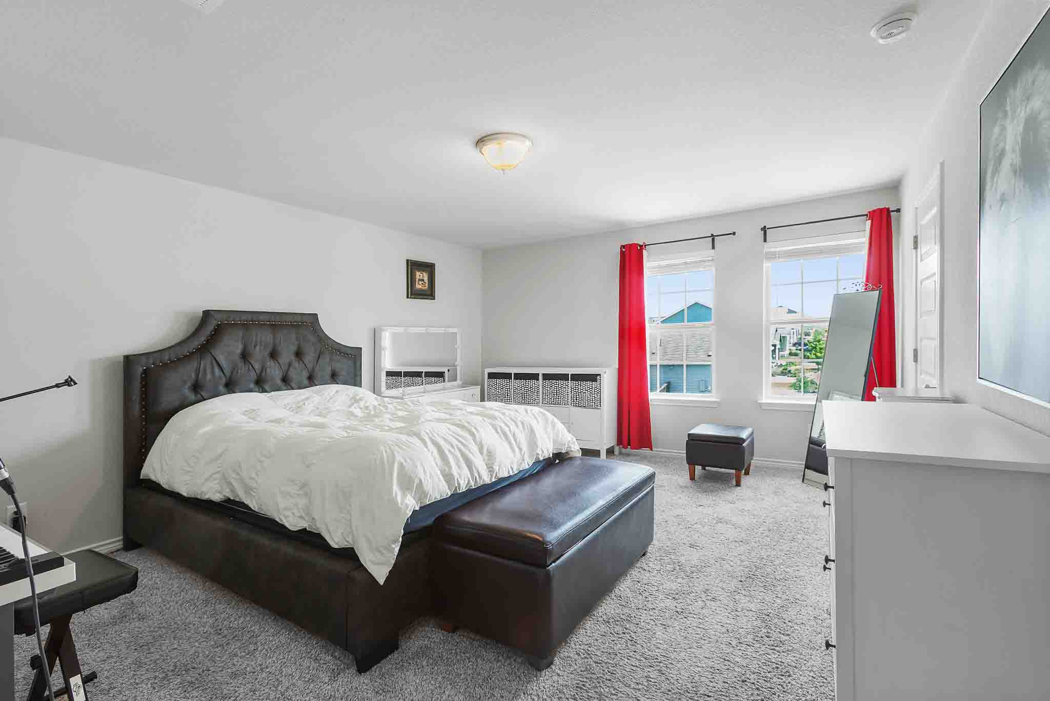 616 Barbary Coast Lane Jarrell, TX 76537 - Photo 19 of 37 a bedroom with bed and large windows
