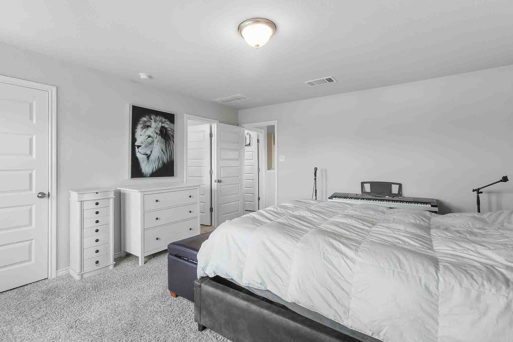 616 Barbary Coast Lane Jarrell, TX 76537 - Photo 20 of 37 a bedroom with a bed and a dresser