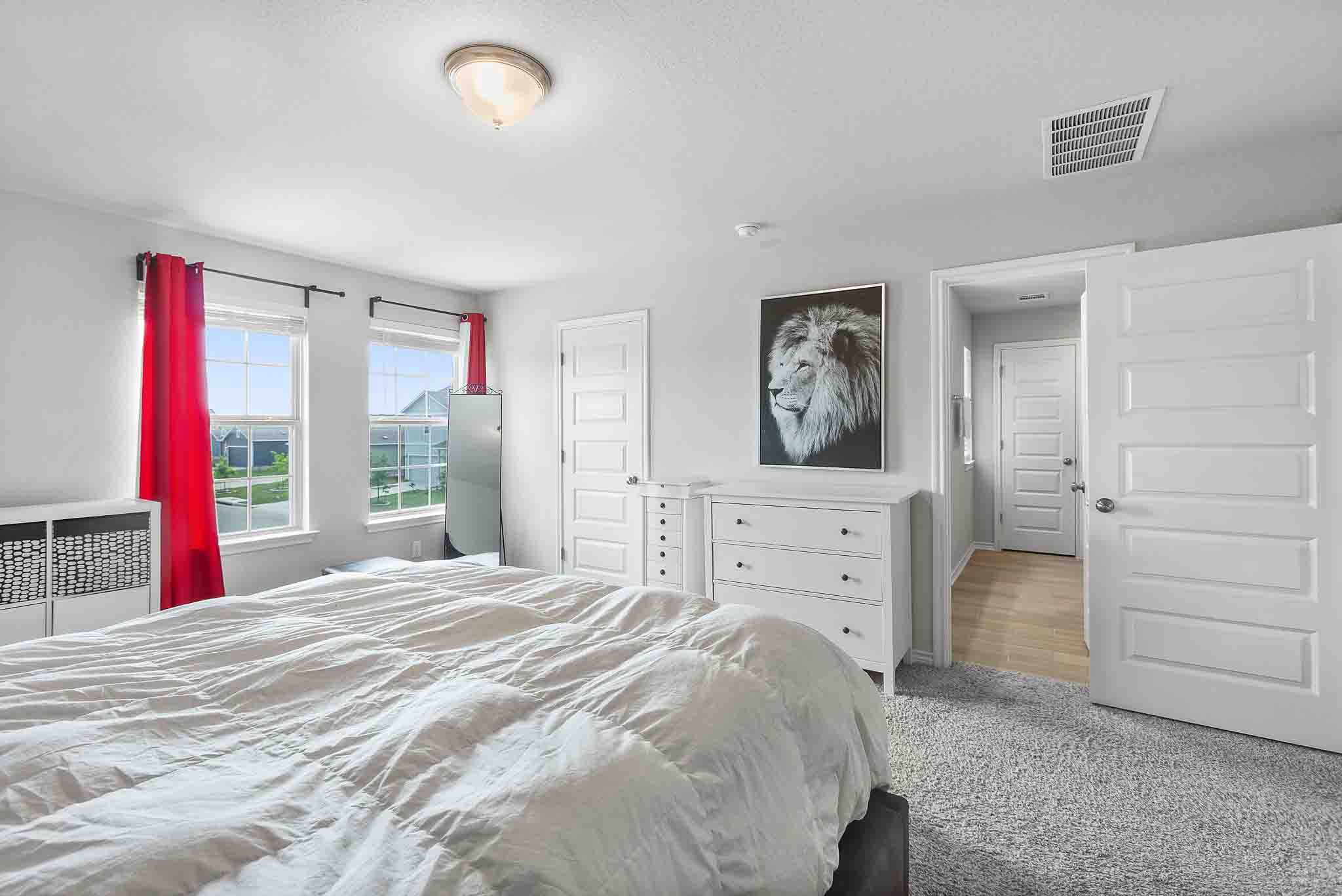 616 Barbary Coast Lane Jarrell, TX 76537 - Photo 21 of 37 a bedroom with a bed and a chandelier