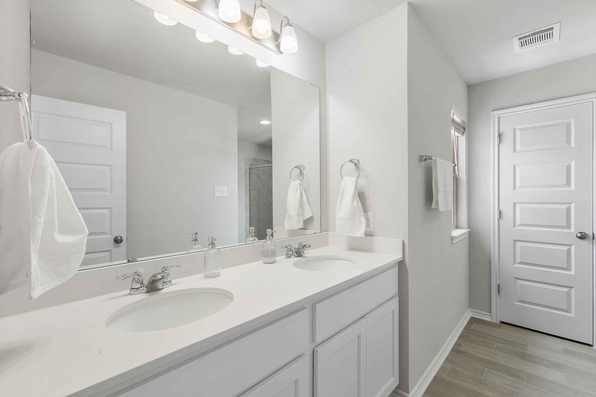 616 Barbary Coast Lane Jarrell, TX 76537 - Photo 22 of 37 a bathroom with a sink vanity and a mirror