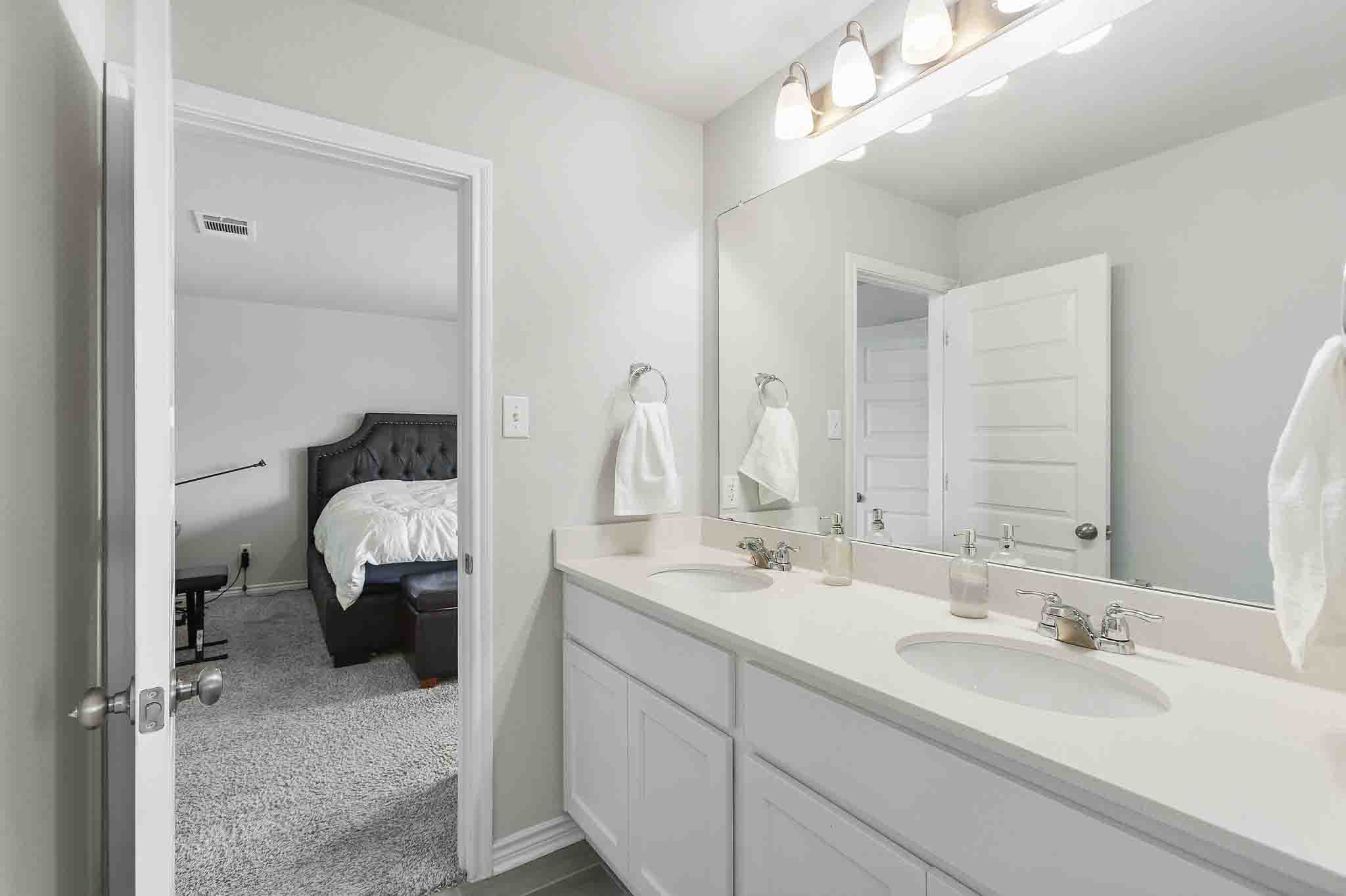 616 Barbary Coast Lane Jarrell, TX 76537 - Photo 24 of 37 a en suite bathroom with double sink and a mirror