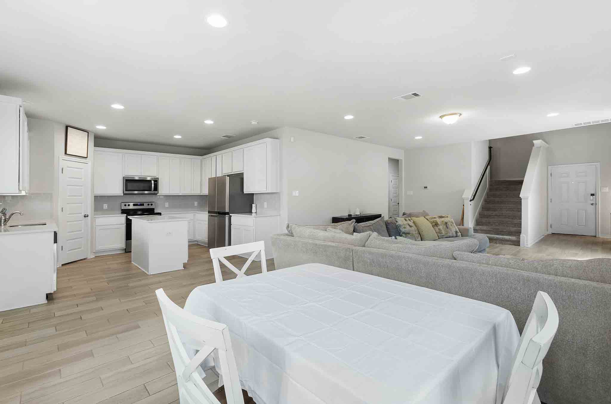 616 Barbary Coast Lane Jarrell, TX 76537 - Photo 7 of 37 a large kitchen with kitchen island a sink table and chairs