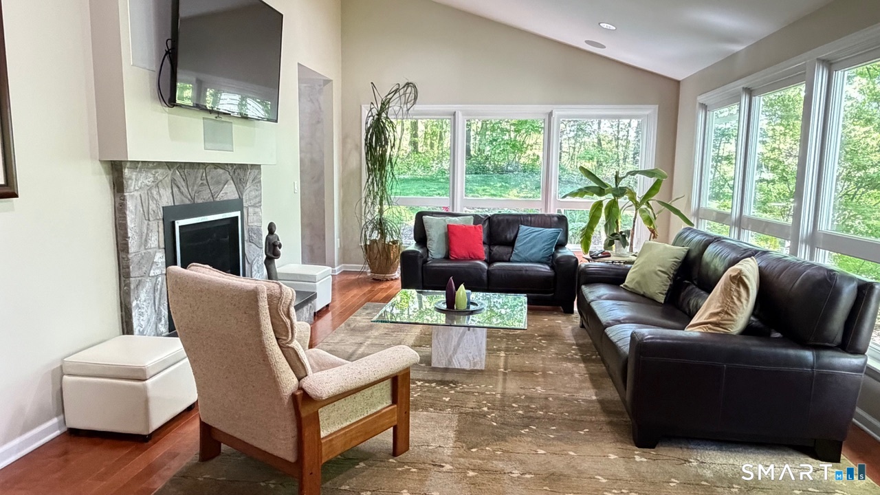 87 Warner Road Berlin, CT 06037 - Photo 12 of 22 a living room with furniture and a fireplace