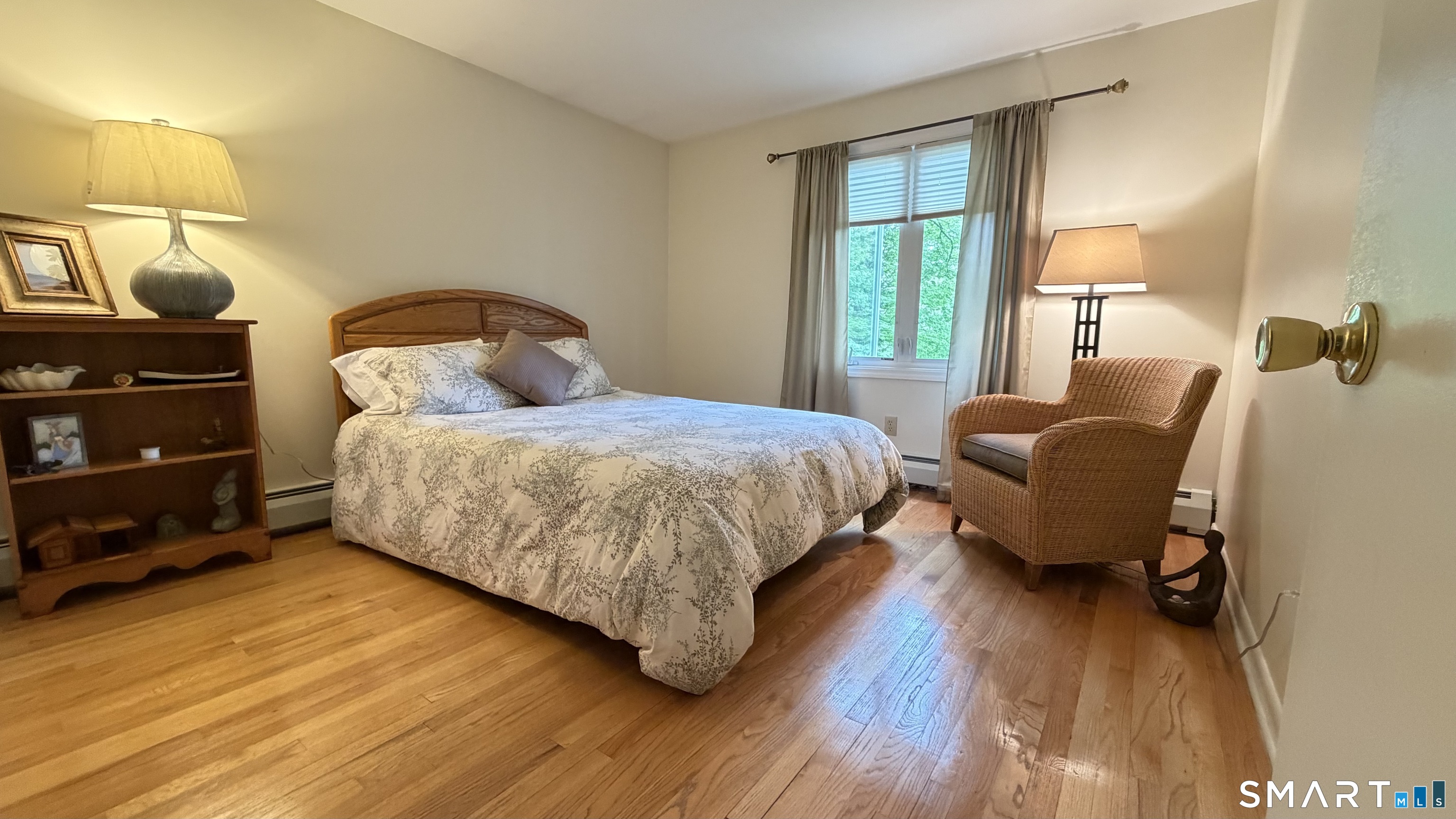 87 Warner Road Berlin, CT 06037 - Photo 14 of 22 a bedroom with a bed and wooden floor