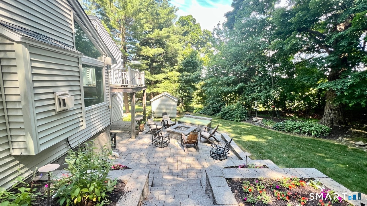 87 Warner Road Berlin, CT 06037 - Photo 3 of 22 a view of a patio with table and chairs and potted plants