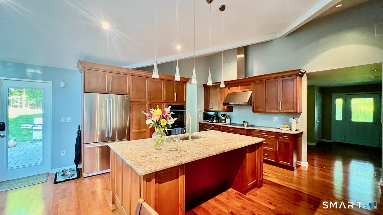 87 Warner Road Berlin, CT 06037 - Photo 5 of 22 a kitchen with stainless steel appliances kitchen island granite countertop a refrigerator a sink and a stove