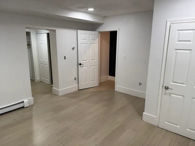 an empty room with wooden floor and closet