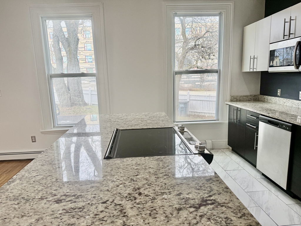 40 Crescent Chelsea Ma, Unit 2 Chelsea, MA 02150 - Photo 3 of 20 a kitchen with a stove a sink and a window