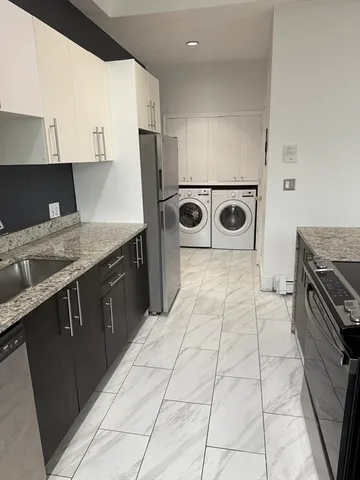 a kitchen with a sink a stove and a refrigerator