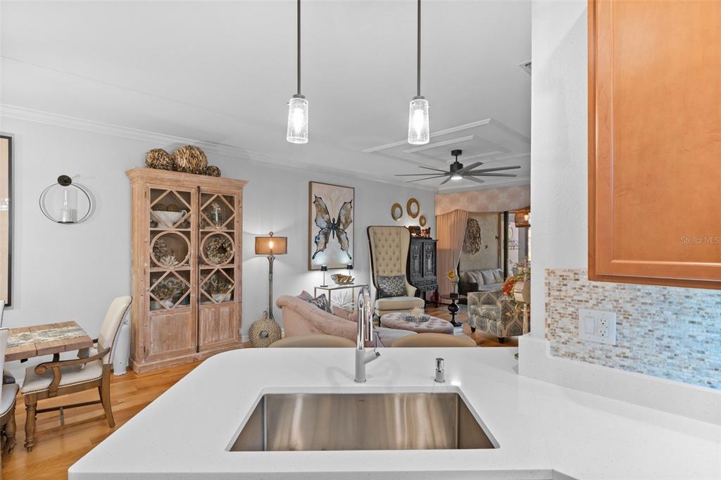 20219 Tesoro Drive Venice, FL 34293 - Photo 24 of 98 a kitchen with a sink a counter and cabinets