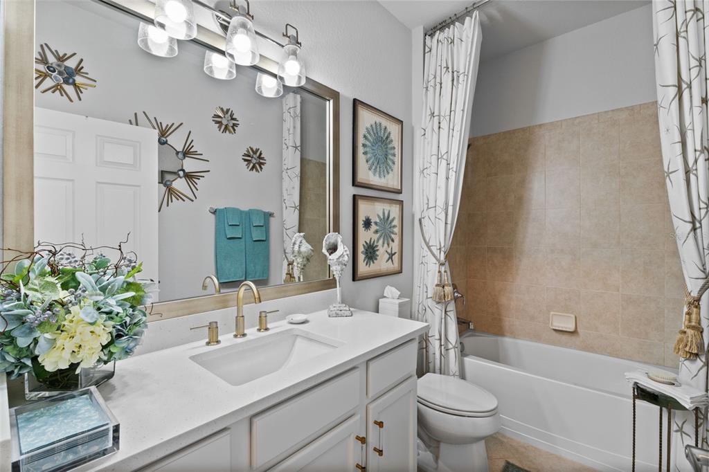 20219 Tesoro Drive Venice, FL 34293 - Photo 44 of 98 a bathroom with a sink a toilet and a mirror