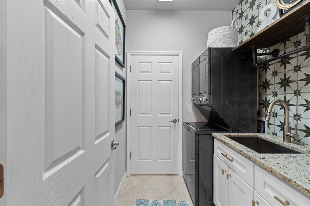 20219 Tesoro Drive Venice, FL 34293 - Photo 46 of 98 a kitchen with white cabinets and black appliances