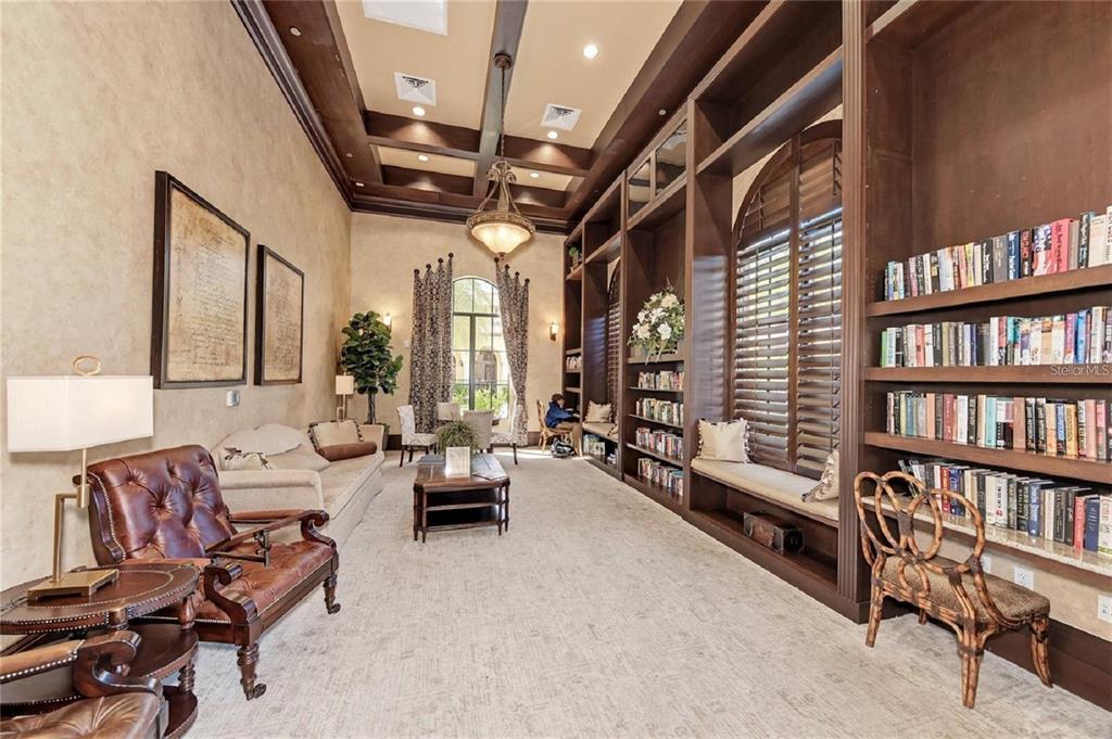 20219 Tesoro Drive Venice, FL 34293 - Photo 69 of 98 a living room with furniture and a book shelf