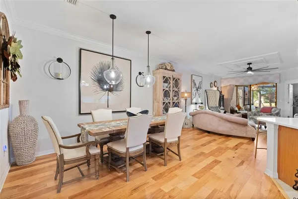a living room with furniture a table and a large window