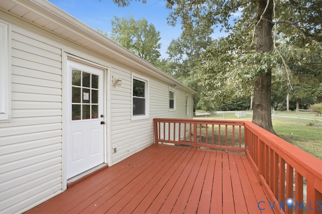 21103 Rabbit Run Petersburg, VA 23803 - Photo 26 of 27 Expansive wood deck with a red finish, white vinyl