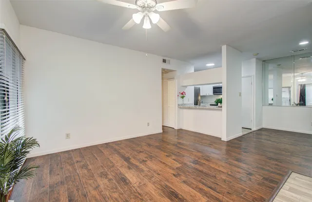 a view of kitchen with cabinets and wooden floor