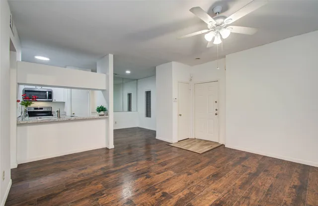 a view of kitchen with cabinets and wooden floor