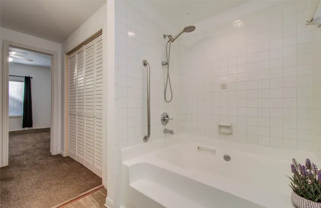 a bathroom with a bathtub and shower