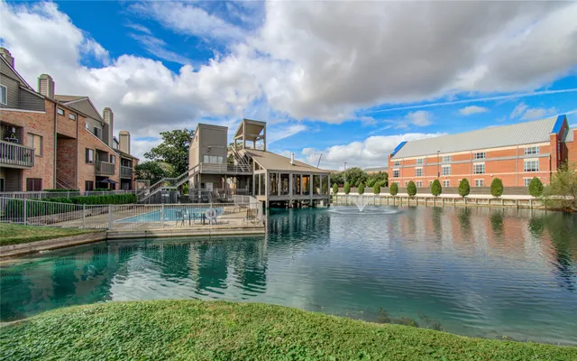 a view of residential houses with outdoor space and lake view