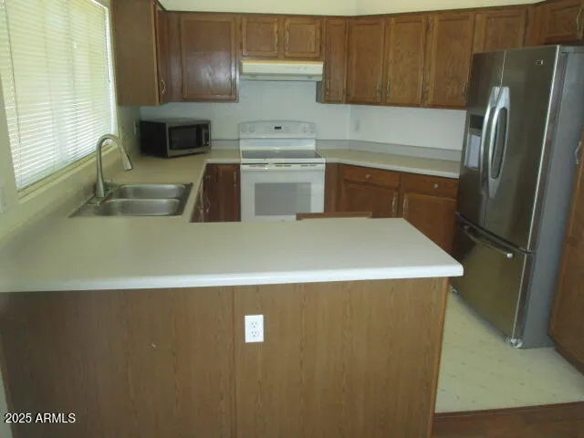 a kitchen with a stove refrigerator and cabinets