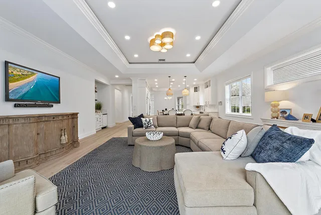 a kitchen with stainless steel appliances a dining table chairs and chandelier