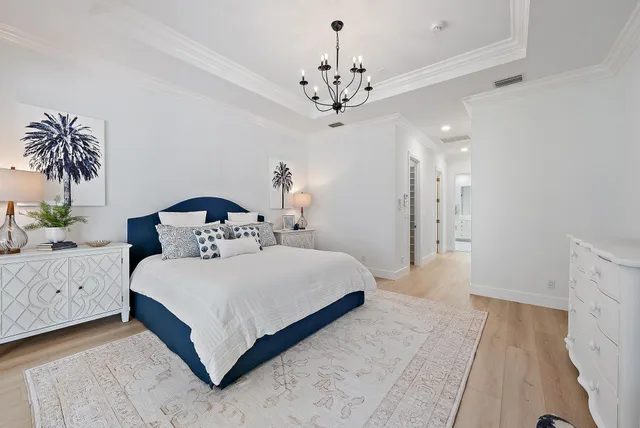 a hallway with white cabinets and wooden floor