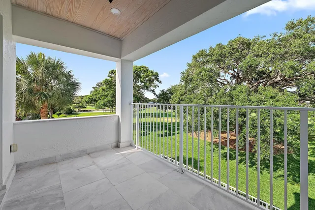 a living room with patio furniture and a garden