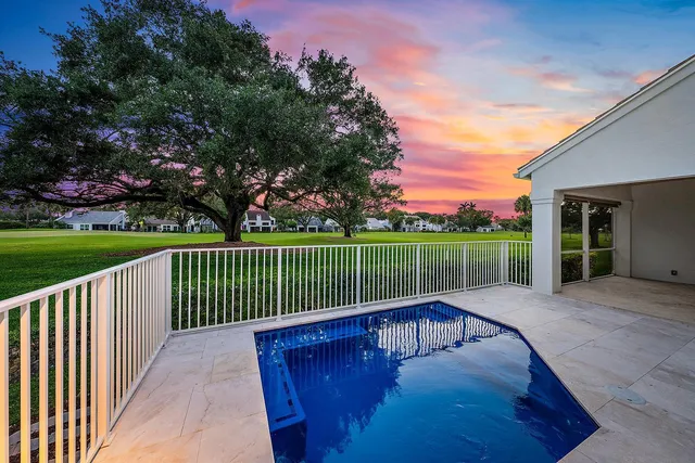 an aerial view of a house with a garden and lake view