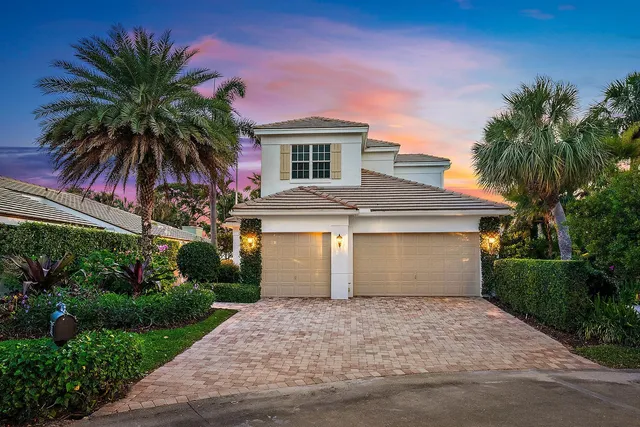 an aerial view of city and lake with trees all around