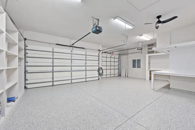 an aerial view of city and lake with trees all around