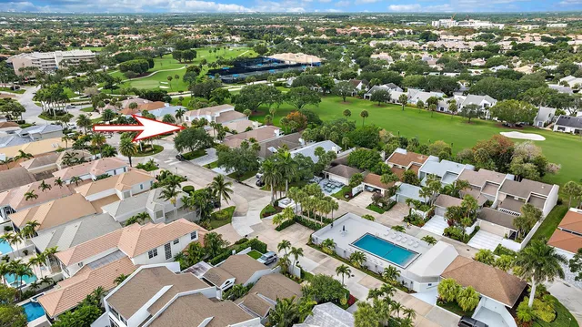 an aerial view of residential houses with outdoor space and trees all around