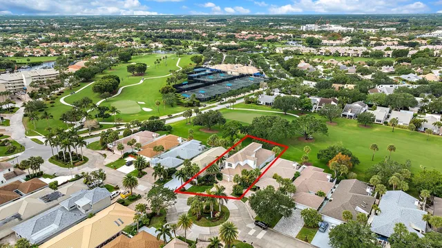 an aerial view of residential houses with outdoor space and street view