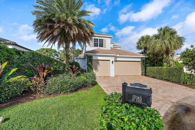 a front view of a house with outdoor seating and flowers
