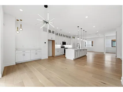 a view of kitchen with wooden floor and electronic appliances