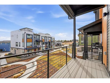 a view of a balcony with wooden floor and city view