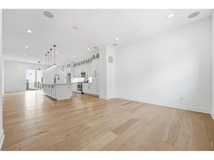 a view of kitchen and hall with wooden floor
