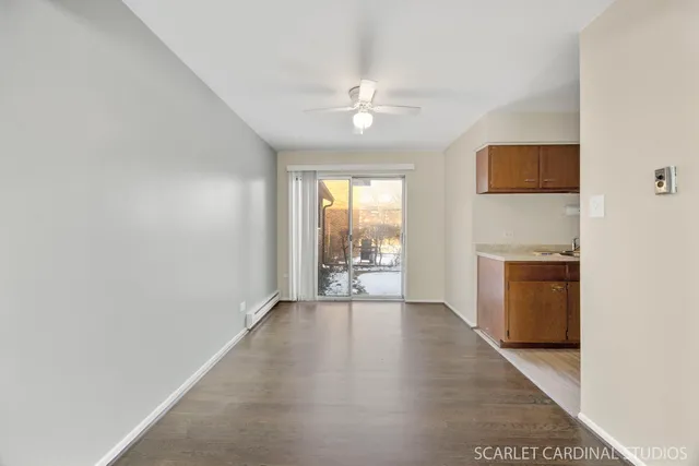 an empty room with windows and a fireplace