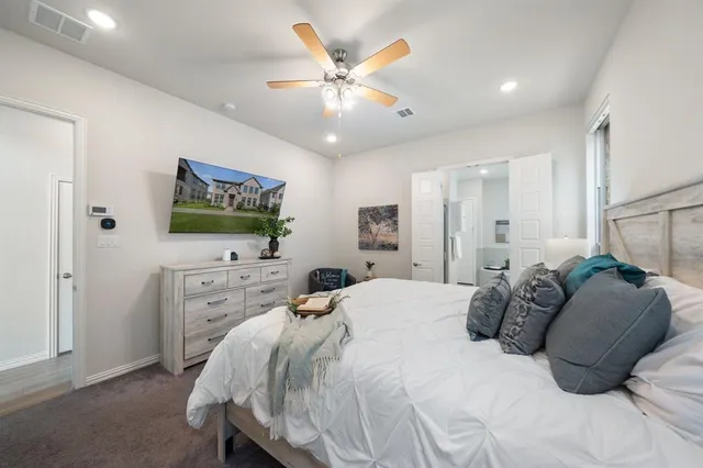 a bedroom with a bed and a flat screen tv