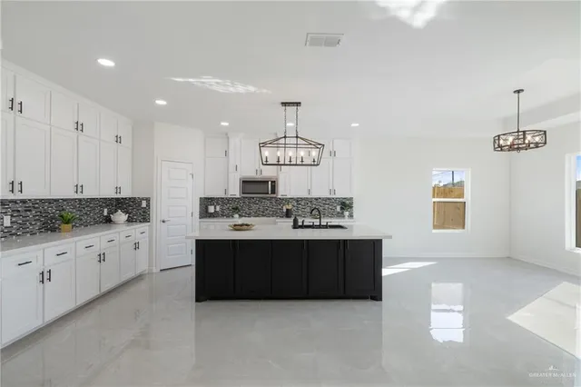 a kitchen with stainless steel appliances granite countertop a stove and a sink