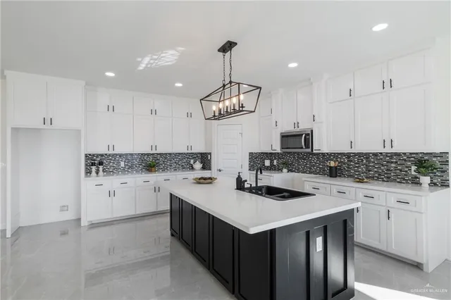 a kitchen with white cabinets stove and refrigerator