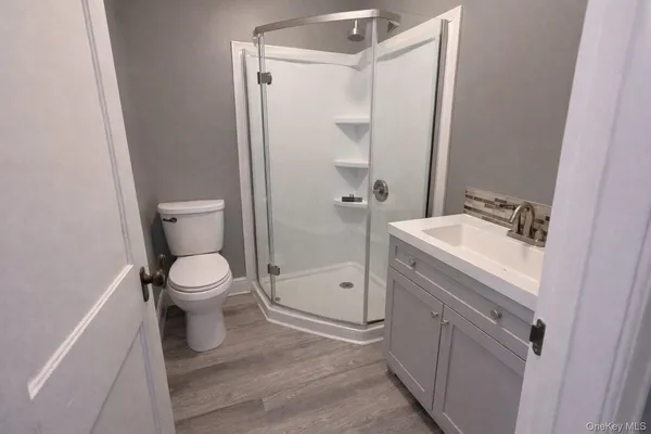 a bathroom with a shower and a sink