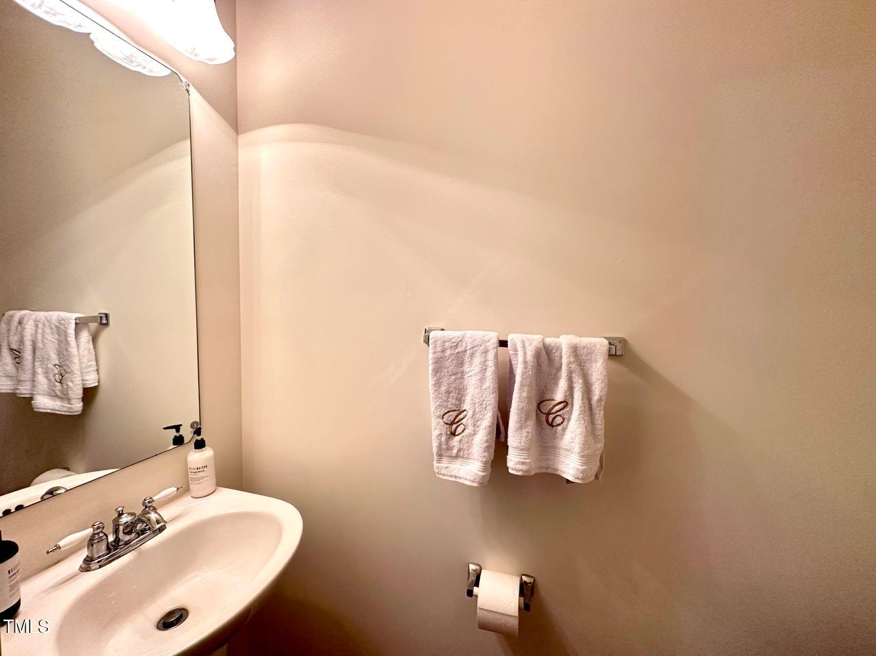 114 Graystar Road Apex, NC 27502 - Photo 7 of 14 a bathroom with a sink and mirror