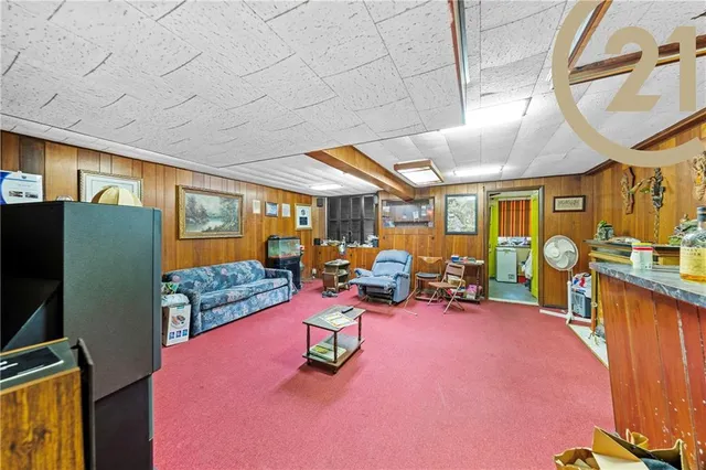 a view of a room with furniture and lots of windows