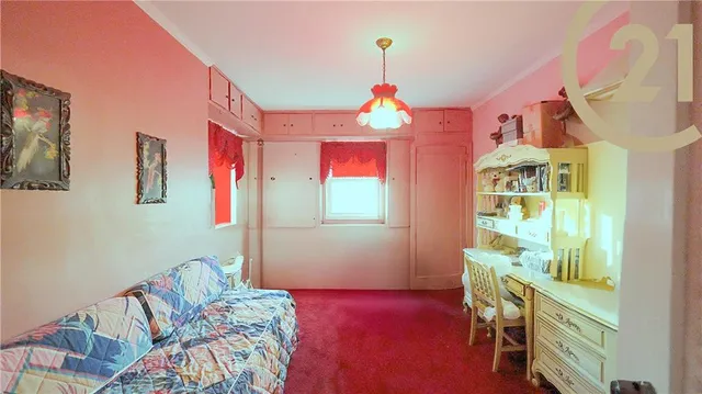 a bedroom with furniture and a wooden floor