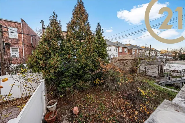 a view of a house with a backyard and a tree