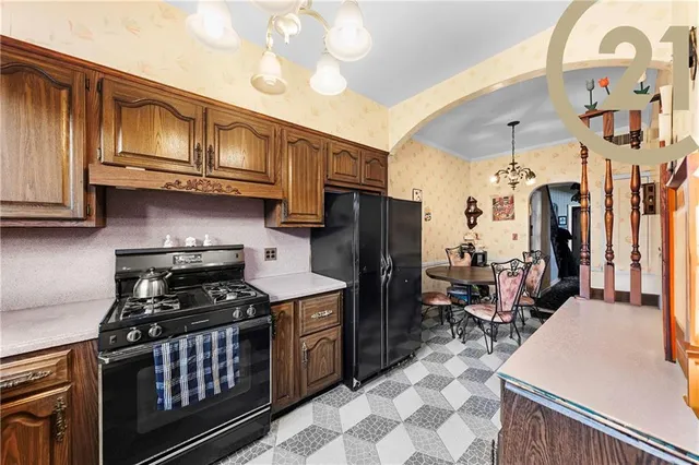 a kitchen with stainless steel appliances granite countertop a stove refrigerator and cabinets